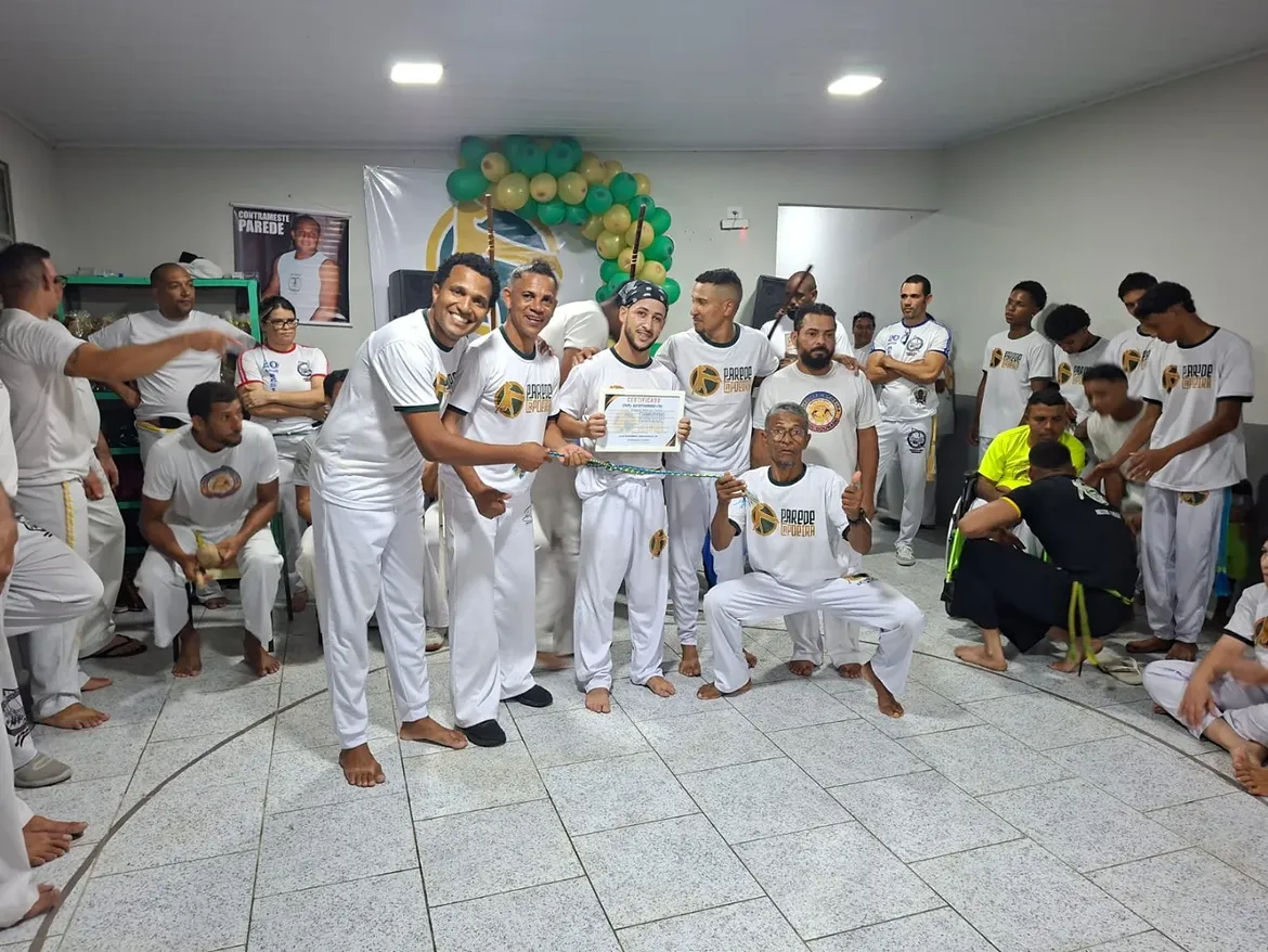 Entrega de certificado e cordão durante evento de graduação